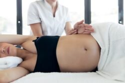 A chiropractor helping a pregnant woman