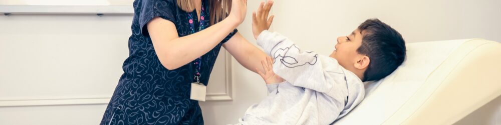 A chiropractor working with a child