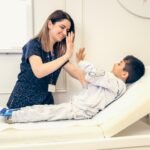 A chiropractor working with a child